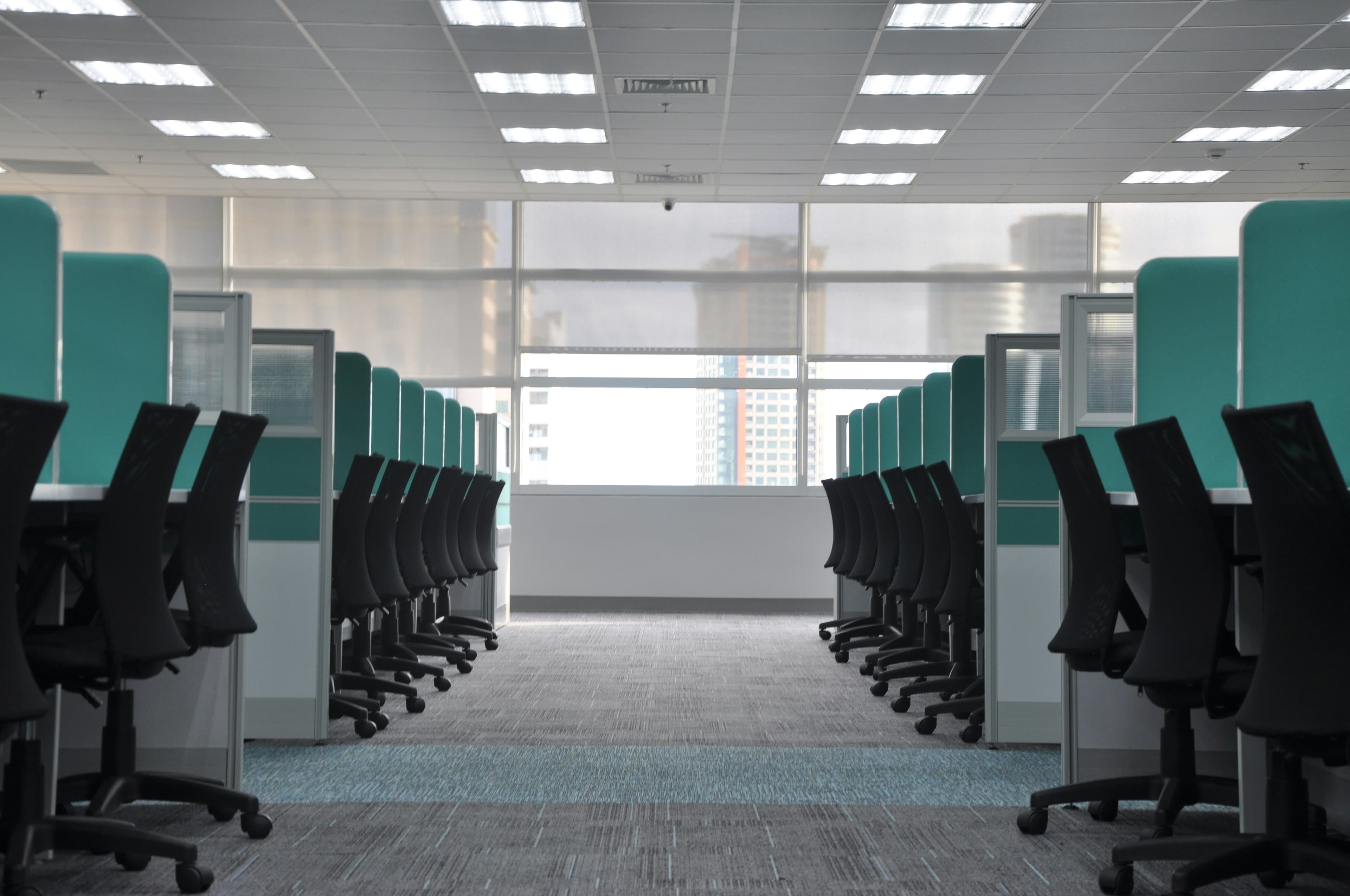 Clean open office workspace with desks and chairs after professional commercial cleaning